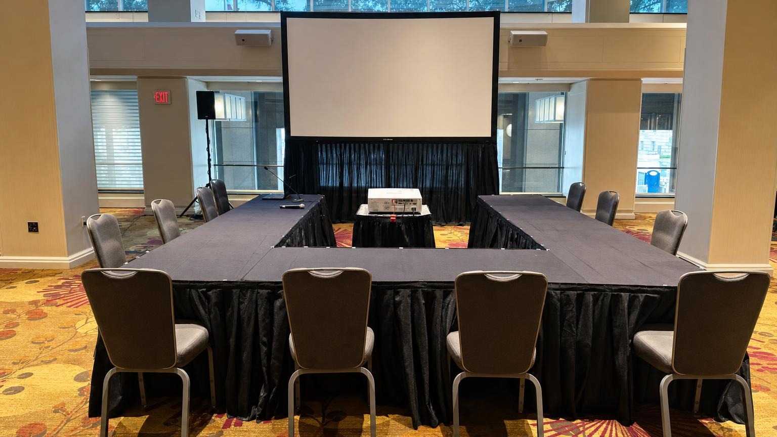 Standard breakout room AV setup with projector, screen, and PA speaker