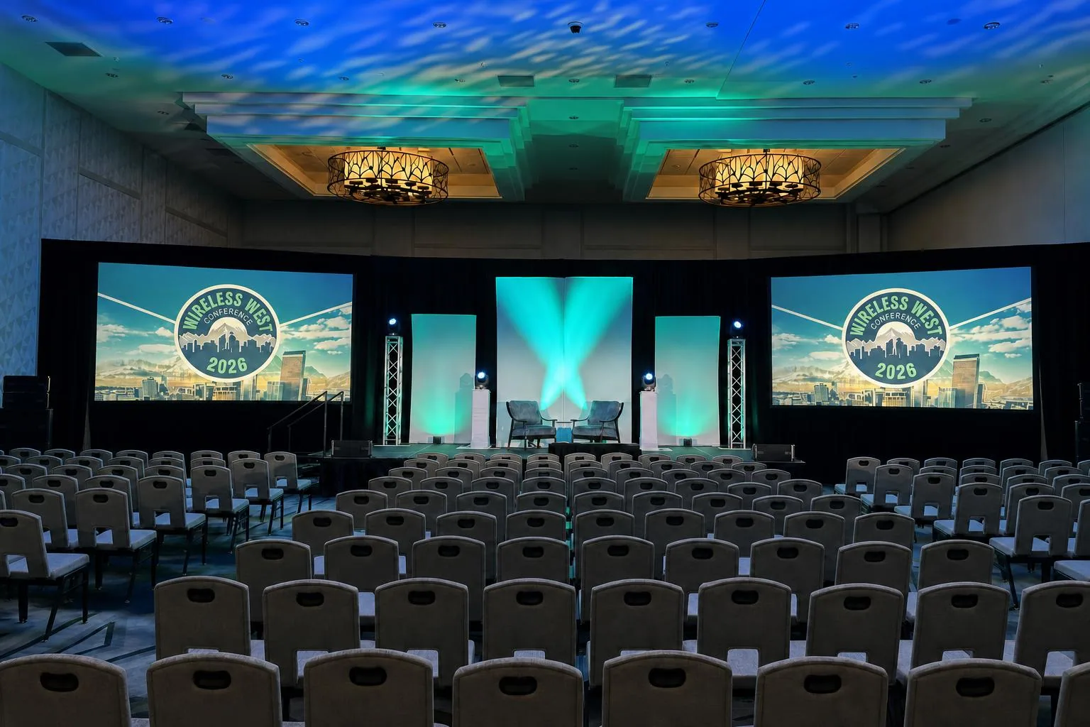 Corporate general session with round tables and stage under warm event lighting