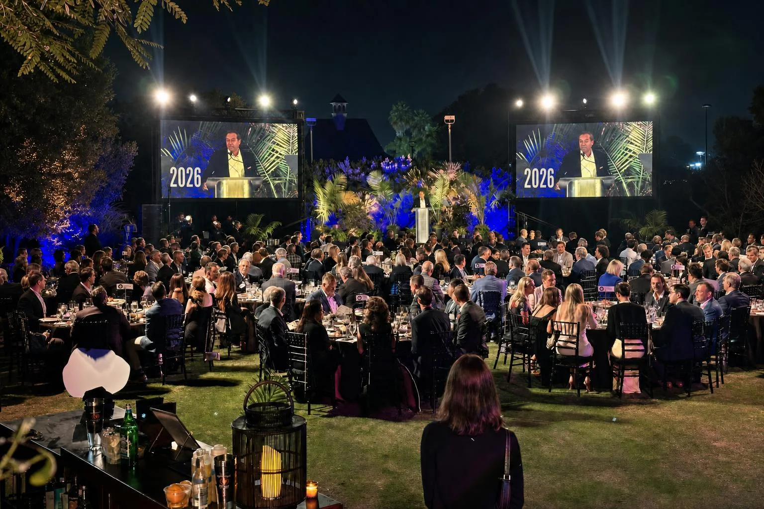 Full ballroom corporate gala production with stage lighting and audience seating
